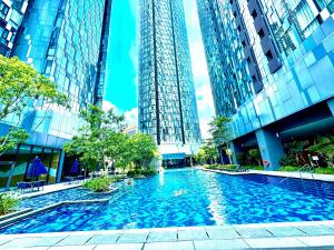 a swimming pool in a city with tall buildings at Star Residence Suite KLCC in Kuala Lumpur