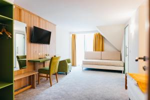 a hotel room with a bed and a desk at Lobogo Resort in Vlăhiţa