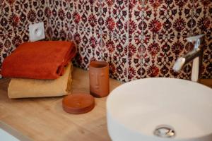 a bathroom with a sink and a towel on a counter at Gîte du Moulin in Pluvigner +11 photos