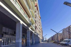 a building on a street with cars parked outside at GuardaViñas24 in Logroño