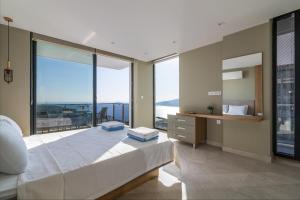 a bedroom with a large bed and a large window at Villa Eliz in Kalkan