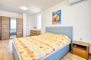 a bedroom with a large bed and a table at Guest House Andrea in Rogachevo +37 photos