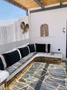a living room with a couch on a patio at Mazi stin Io in Ios Chora
