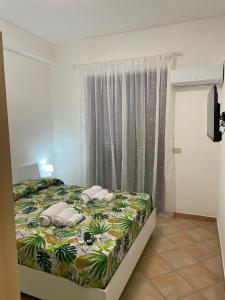 a bed with two pillows on it in a bedroom at casa vacanza apollonia in Finale