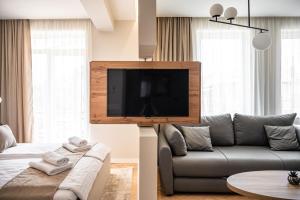 a living room with a couch and a flat screen tv at Bitola Apartments in Bitola