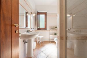 a bathroom with a sink and a tub and a toilet at Residenza Parco degli Ulivi in Villamassargia +31 photos
