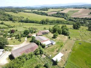 an aerial view of a farm with buildings and trees at MOBIL-HOME Ferme La Fée Spiruline AURIGNAC in Aurignac
