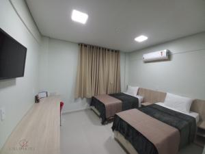 Postel nebo postele na pokoji v ubytování CALLAI HOTEL