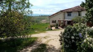 a house on the side of a dirt road at MOBIL-HOME Ferme La Fée Spiruline AURIGNAC in Aurignac