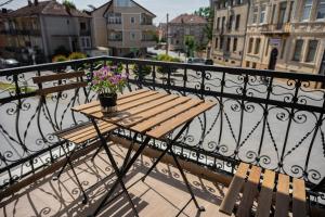 a wooden table with a potted plant on a balcony at Bitola Apartments in Bitola
