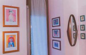 a mirror in a room with pictures on the wall at Villa Anna - Bike Friendly in Buonconvento
