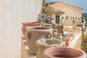 a row of clay pots lined up on a wall at Villa Edda in Noto