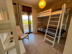 a room with a bunk bed and a ladder at Manuela's Stone Heaven Retreat in Kalandra
