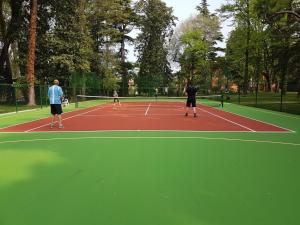 a group of people playing tennis on a tennis court at Hotel Vela d'Oro Dependence in Bardolino