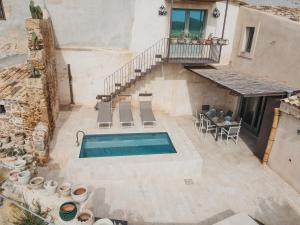 an overhead view of a swimming pool in a building at Villa Edda in Noto