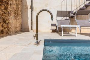 a water fountain in front of a swimming pool at Villa Edda in Noto +93 photos