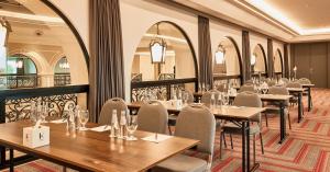 a row of tables and chairs in a restaurant at Erbil International Hotel in Erbil