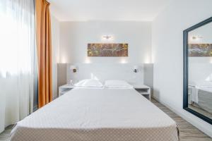 a white bedroom with a large bed and a window at Confidence Hotel San Silvestro in San Prospero  +75 photos