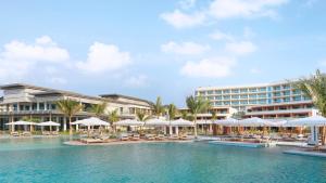 a resort with a pool with chairs and umbrellas at InterContinental Ras Al Khaimah Mina Al Arab Resort & Spa, an IHG Hotel in Ras al Khaimah