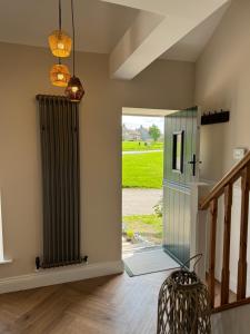 a hallway with a sliding glass door to a yard at Chestnut Cottage Ravensworth in Richmond +12 photos