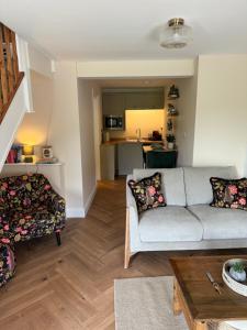 a living room with a couch and a table at Chestnut Cottage Ravensworth in Richmond