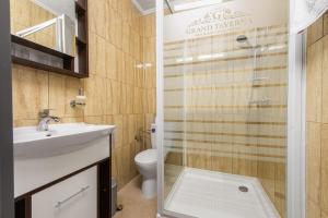 a bathroom with a shower and a sink and a toilet at Grand Taverna Boutique -Adults Only in Vama Veche
