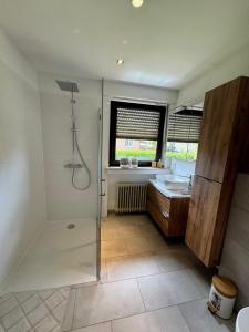 a bathroom with a shower and a sink at Ferienhaus Zipfelstube in Selfkant +12 photos