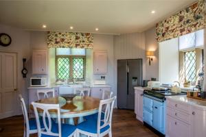 a kitchen with a table and some chairs and a table at The Hunting Tower in Baslow