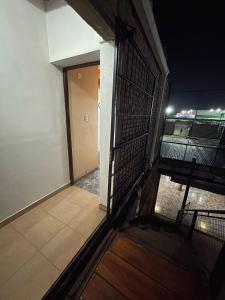 an open door to a room with a balcony at Belgrano in San Fernando del Valle de Catamarca +6 photos