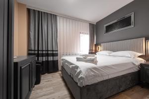 a bedroom with a large bed and a window at Grand Taverna Boutique -Adults Only in Vama Veche +38 photos