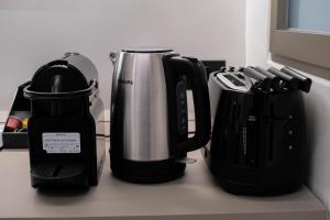 a counter top with a coffee pot and a coffeemaker at barneys design apartment in Taranto