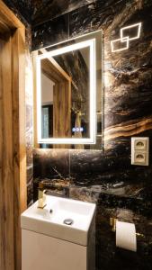 a bathroom with a white sink and a mirror at Dream House - Vysoké Tatry in Vysoké Tatry +20 photos