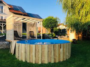 a swimming pool in a yard with a wooden fence at FeWo zum Heuweg in Hofkirchen