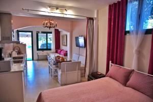 a bedroom with a living room and a dining room at Sunrise & Sunset apartments in Monemvasia