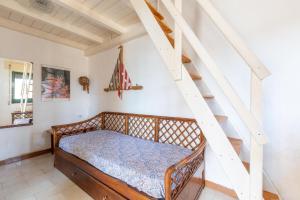 a bedroom with a bed and a staircase at Villetta Stella by BarbarHouse in Torre Colimena