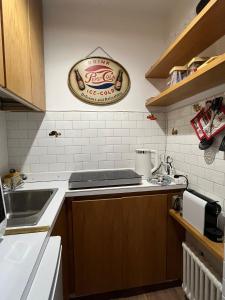 a kitchen with a sink and a sign on the wall at L'altra casa del Cervino in Breuil-Cervinia +11 photos