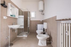 a bathroom with a toilet and a shower and a sink at Oasi Rinascimentale con Giardino in centro Ferrara in Ferrara +17 photos