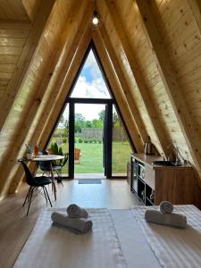 a large attic bedroom with a large window at Honey Glamping Resort with jacuzzi in Tomislavgrad