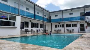 a child playing in a swimming pool in a building at Douglas Highway Inn Hotel in Cabo Rojo