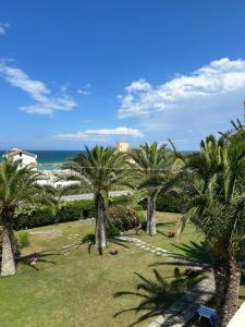 a group of palm trees in a park with the ocean at Spazio DIBA in Ortona