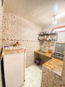 a small kitchen with a counter and a sink at Dallas Private Surf Apartment in Agadir