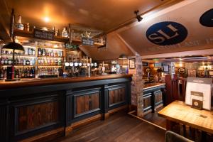 a bar in a pub with a bar counter at The Seaton Lane Inn - The Inn Collection Group in Seaham