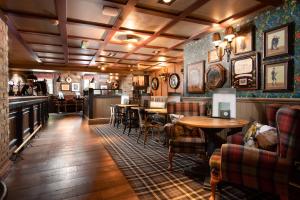 a restaurant with tables and chairs and a bar at The Seaton Lane Inn - The Inn Collection Group in Seaham