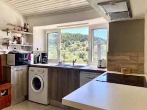 a kitchen with a sink and a washing machine at Villa Christina in Lákka