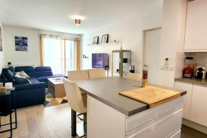 a kitchen and living room with a table and a couch at All comfort -Parking&Fibre #WelcomeHome Gare Colombes in Colombes +15 photos