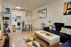 a living room with a couch and a coffee table at All comfort -Parking&Fibre #WelcomeHome Gare Colombes in Colombes