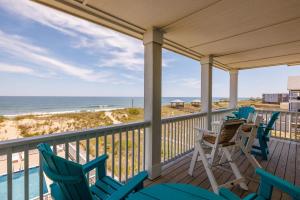 a porch with chairs and a view of the beach at SC304 - Top of the Banx in Kill Devil Hills
