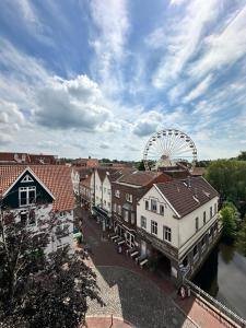 a city with a ferris wheel in the background at Hotel Zur Mühle in Buxtehude