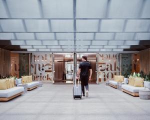 a man walking down a hallway with a suitcase at Lux Aka Brickell Condo in Miami +230 photos