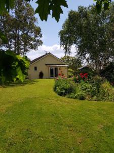 a house in a yard with flowers and plants at Sundial Cottage in Newton Abbot +11 photos